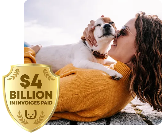 Woman laying on a seawall with her pet dog sitting on her. Trupanion $2 billion logo in the corner.