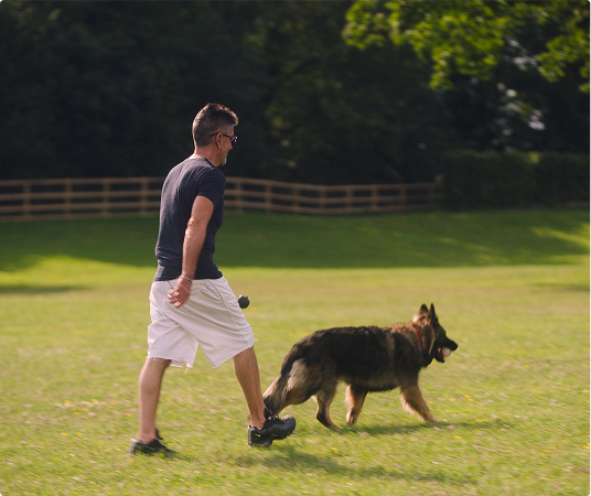 Simon and dog walking in the park