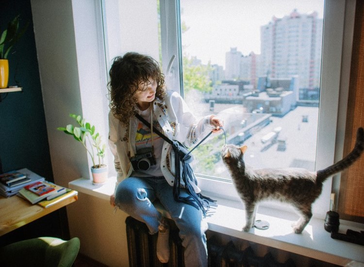 owner playing with her cat indoors